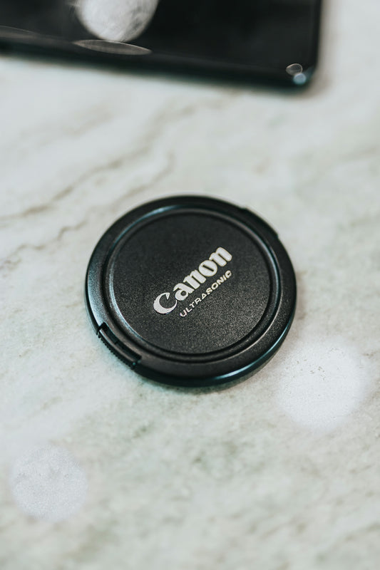 black nikon camera lens cover