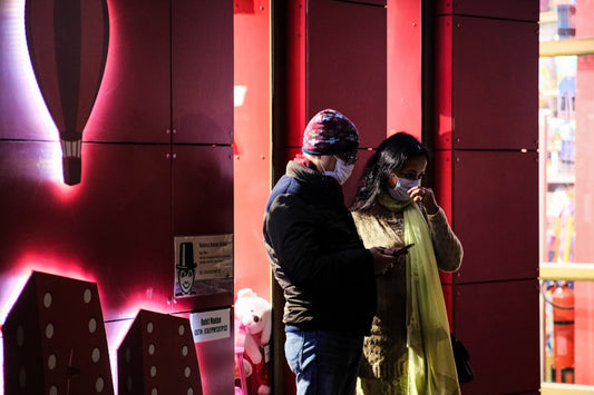 a man and a woman standing in front of a store