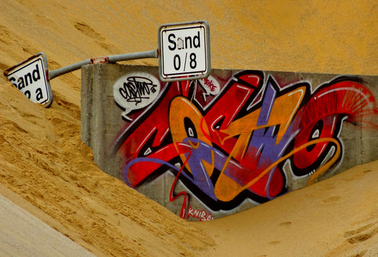 a red and white sign on a wooden surface