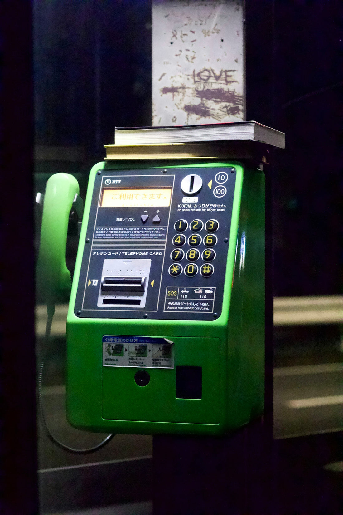 a green telephone with a white display