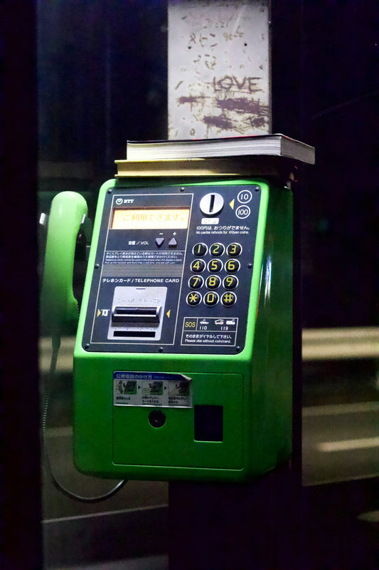 a green telephone with a white display