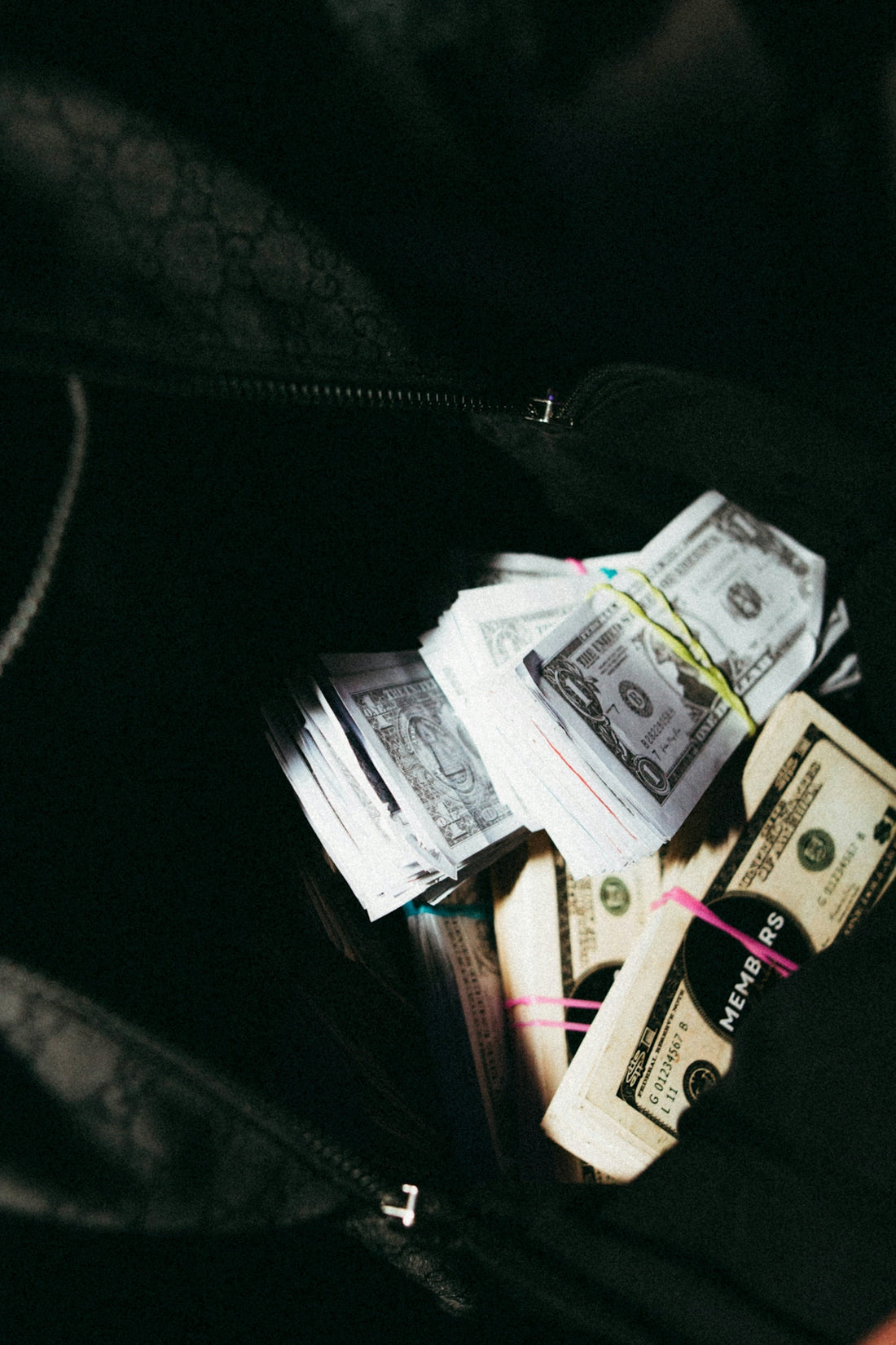 a bag filled with lots of money sitting on top of a table