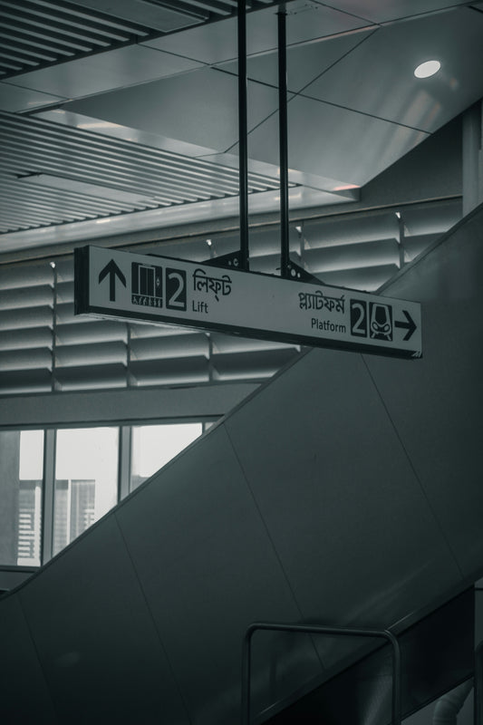 a black and white photo of an escalator