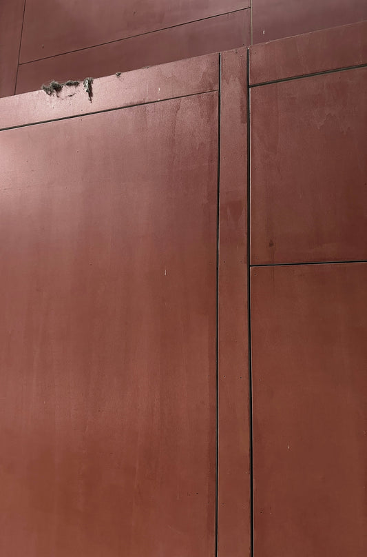 a red building with a clock on the side of it