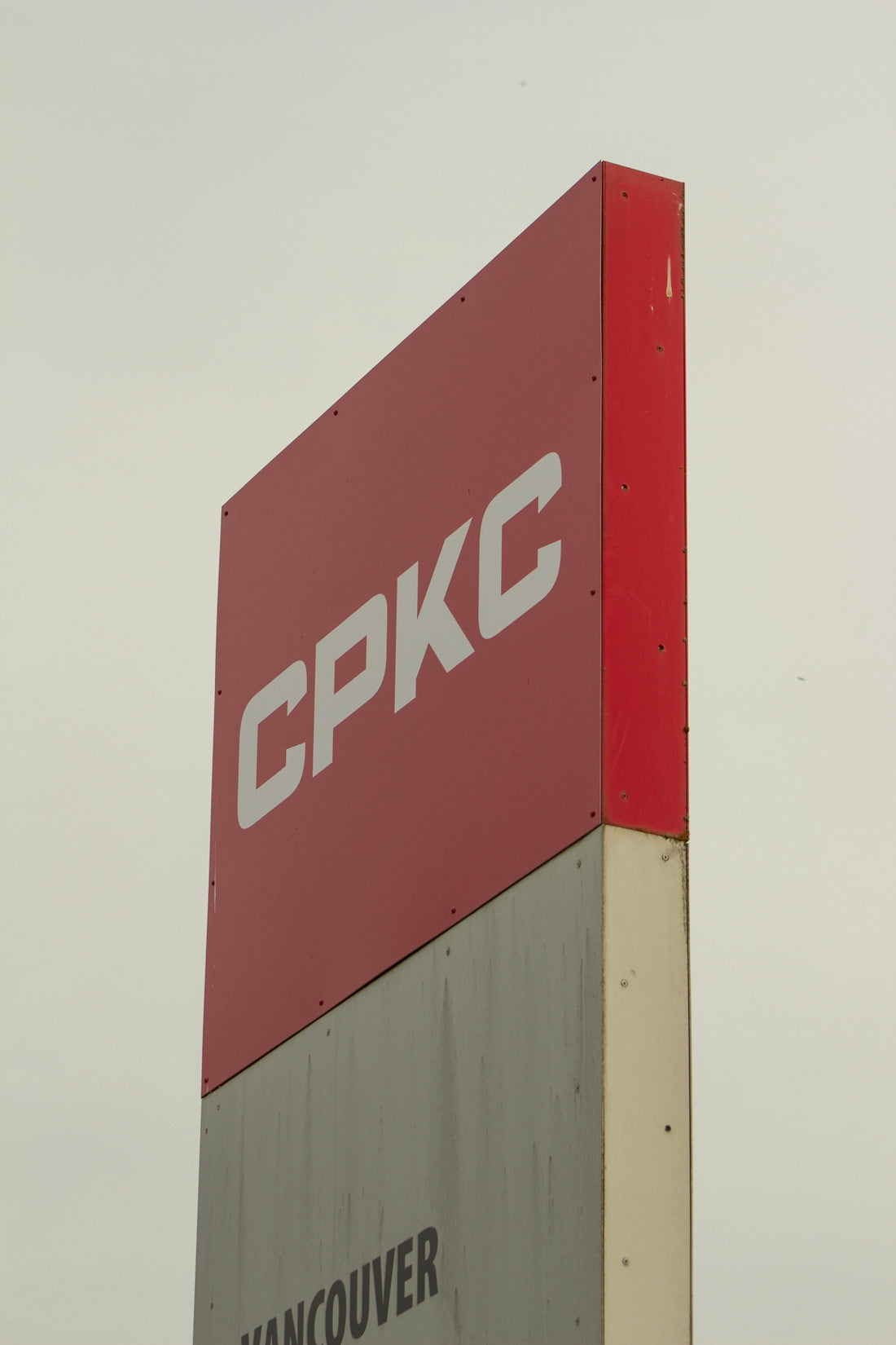 a red and white sign for a gas station