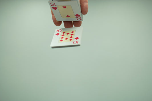 a person holding a playing card in their hand