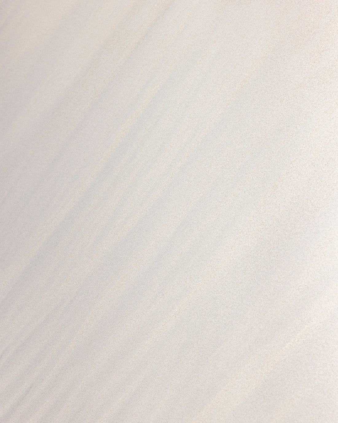 a man riding a snowboard down the side of a snow covered slope