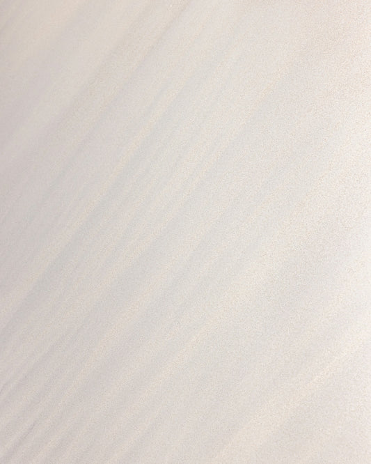 a man riding a snowboard down the side of a snow covered slope