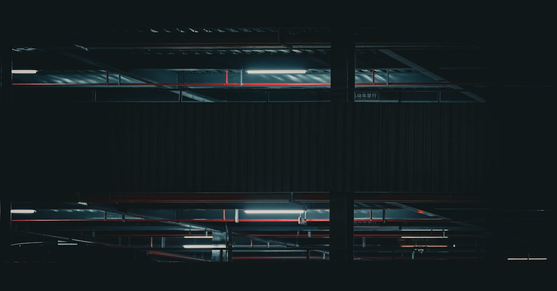 A black and white photo of a window in the dark