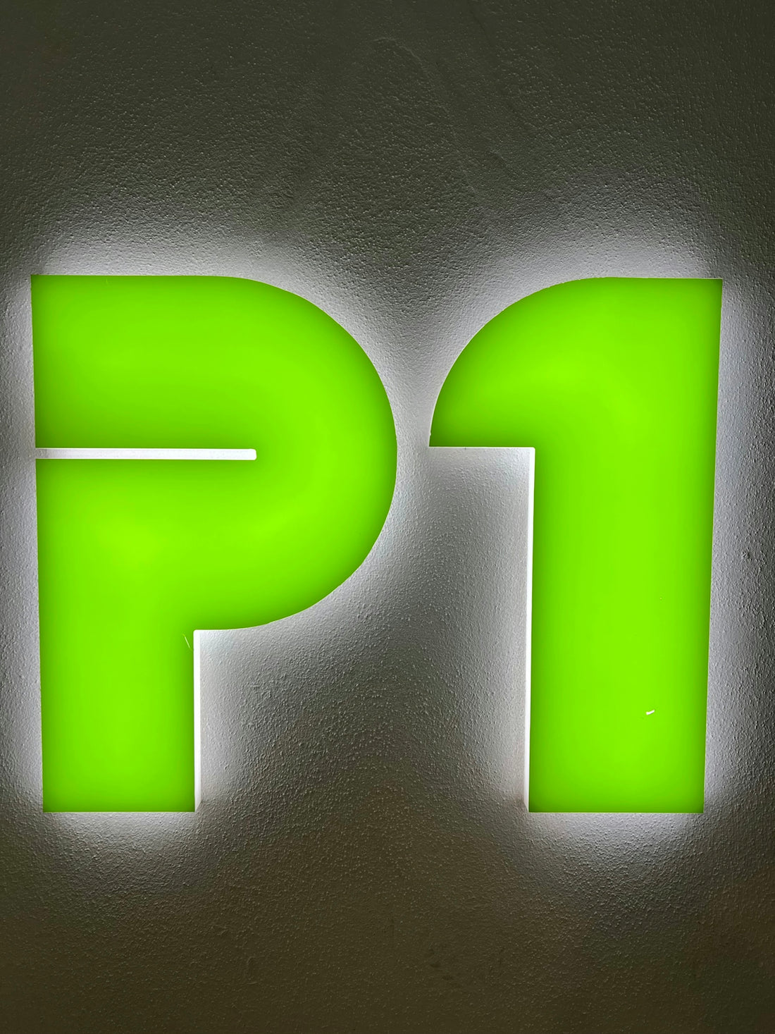 The image shows a green p1 illuminated sign.