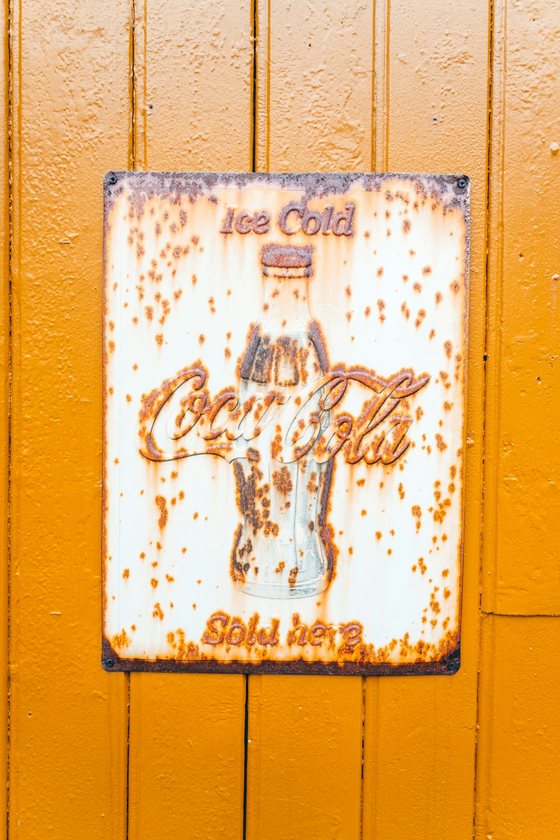 Vintage coca-cola sign on a wooden wall