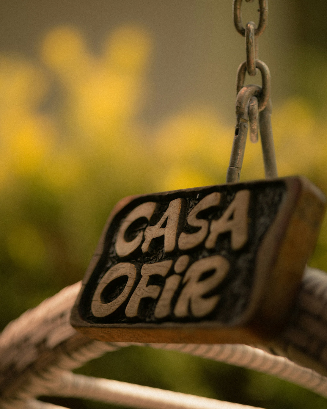 Wooden sign with text casa ofir hanging
